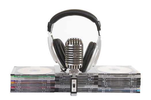 Front view of headphones, vintage microphone, cd, dvd stack