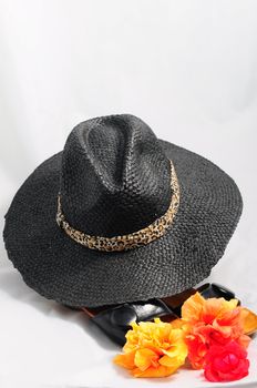 Ladies' black hat against the sun and black sandals.