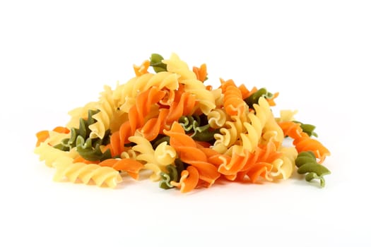 Raw colored pasta fusilli isolated on white background