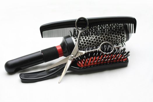 A pair of hairdressers scissors, a comb and brushes, the basic equipment for any hairdresser