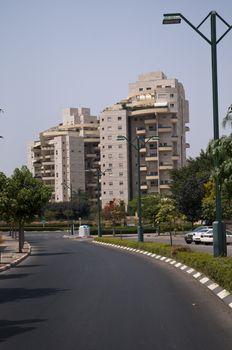 Front view urban apartment building with close balconies .