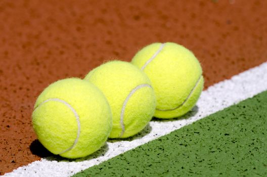  Tennis balls on a tennis court.