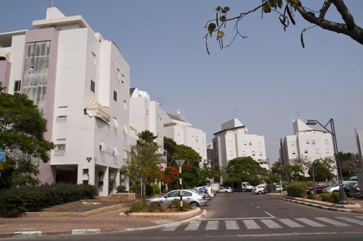 Front view urban apartment building with close balconies .