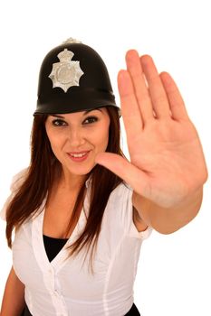 Beautiful brunette woman wearing a toy police hat and hand out in stop sign