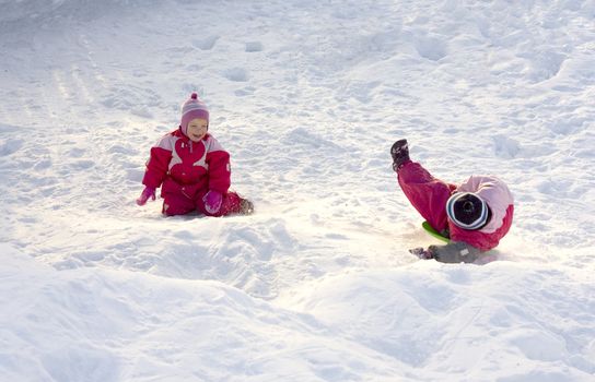 Two happy children playing in the snow