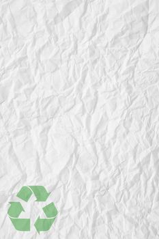texture of white crumpled paper and green recycling sign