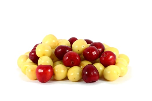 Heap of sweet red and yellow cherries isolated on white