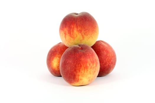 fresh colorful ripe peaches isolated on white
