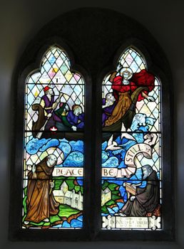 Historic stained glass window, christian theme.