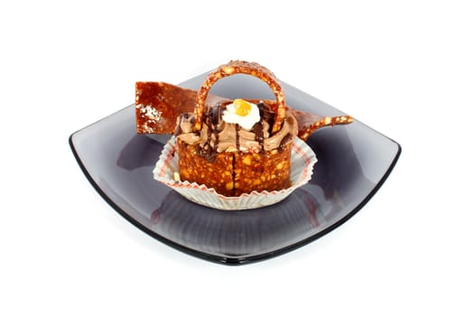 Little sweet candy basket on black glass plate isolated on white