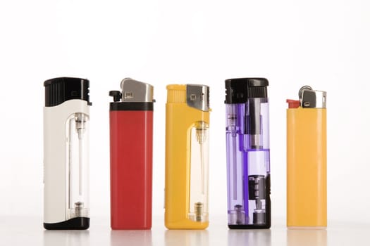 front view of colored lighters on white background