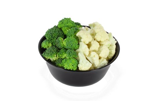 Pieces of fresh broccoli and cauliflower in a black bowl isolated on white