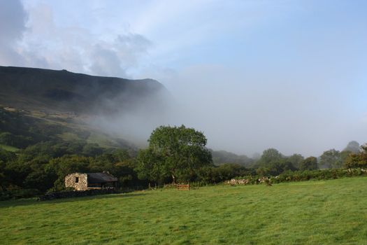 Mist rolling up a valley