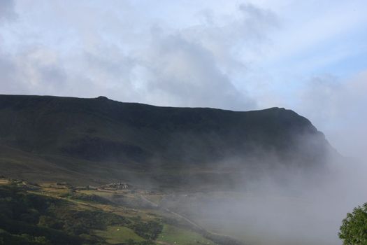 Mist rolling up a valley