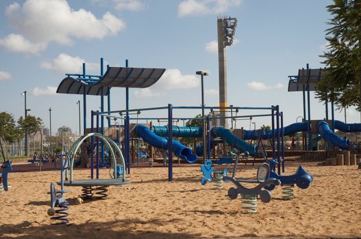 A view from a colorful playground under a beautiful clean blue sky .