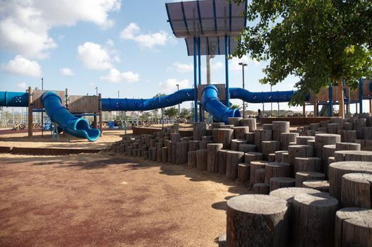 A view from a colorful playground under a beautiful clean blue sky .