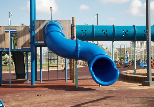 A view from a colorful playground under a beautiful clean blue sky .