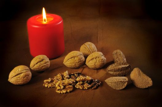 Beautiful artistic still life of hard nuts under candle light