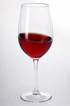 a glas of red wine with white background