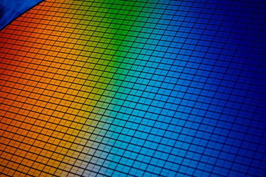 detail of a silicon chip wafer reflecting different colors