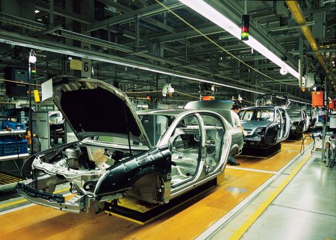 car production line with unfinished cars in a row