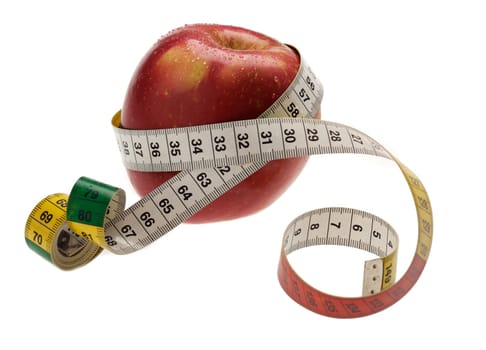 red apple with measuring tape wraped arround