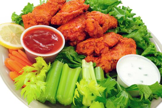 Spicy buffalo chicken wings served with hot and sour dip and crispy veggies
