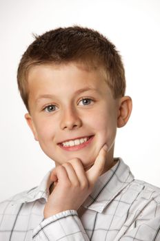 cute young boy thinking with positive expression 