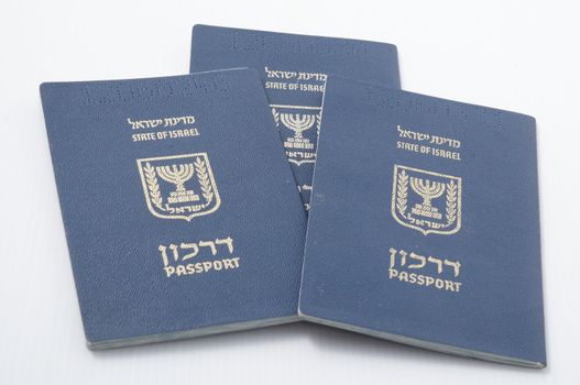 Three Israeli passport isolated on a white background.