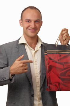 A young man wearing a jacket with a gift bags .