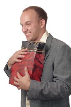 A young man wearing a jacket with a gift bags .