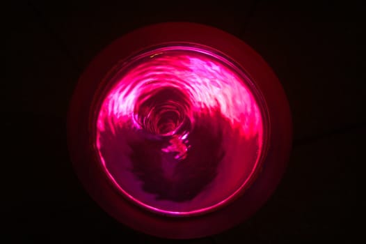 Pink water vortex with swirling water