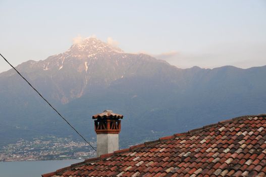 View over old roof on the Lake Como and Colico during sunset