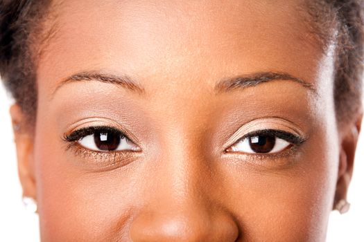 Beautiful almond shaped eyes with natural makeup cosmetics of an African young attractive woman, looking at camera.