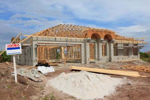 Block home with roof trusses on,  under construction front view