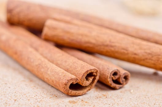 Cinnamon stick closeup on a brown background