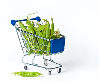 metal shopping trolley filled with green peas