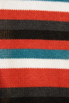 closeup of colorful striped fabric with red blue white and black stripe