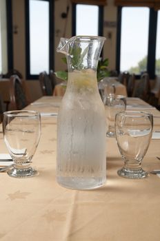Table setting with a jug of water .