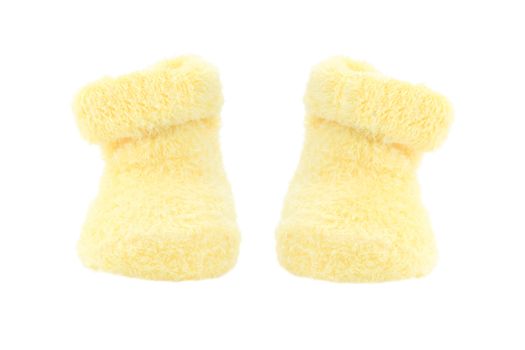 Cute little yellow baby booties isolated on white.