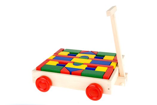 colorful building blocks in a trolley on a white background