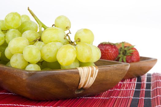 grapes in a wooden tray and strawberries