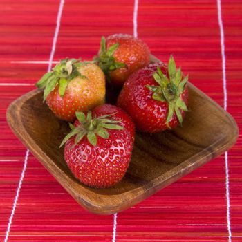 strawberries in a wooden tray