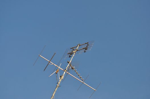 Detail of TV aerial antenna over a blue sky