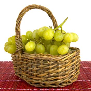 grapes in a basket on a red plaid