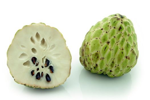 Custard-Apple (Annona Squamosa) . Whole fruit and cross-section, showing creamy white flesh and dark seeds. Shot on white