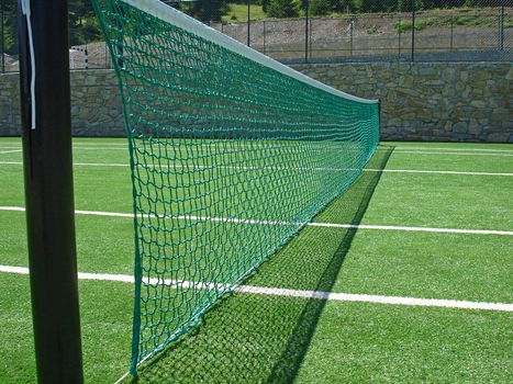  tennis net on empty tennis field                              