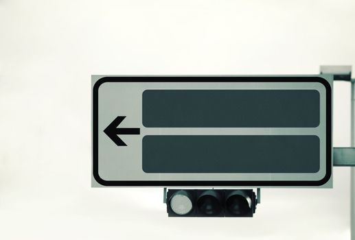 Traffic lights and a direction sign , sepia toned retro style photo with space for your text