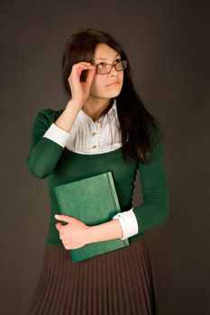 Businesswoman holding her glasses and notebook