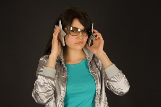 Fashion girl listening to stars isolated on black background